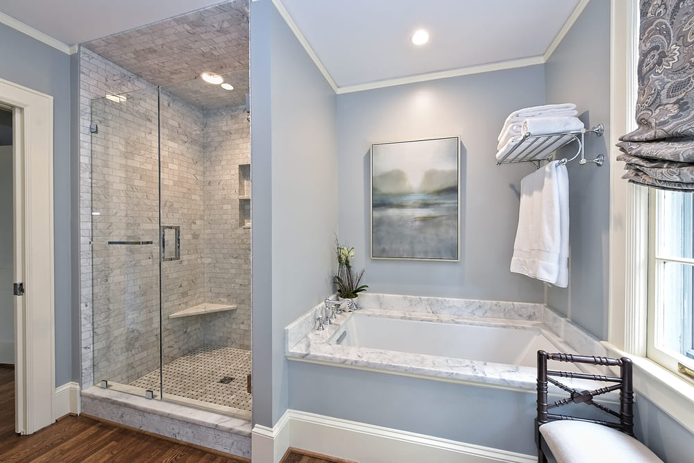 bathroom with blue walls and separate shower and bath by hopedale builders in charlotte