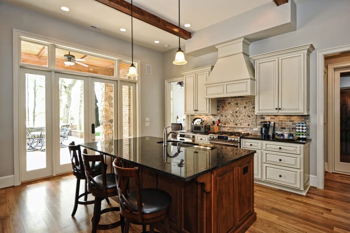 brown rustic kitchen with black countertops and textured backsplash in Charlotte, NC by Hopedale Builders