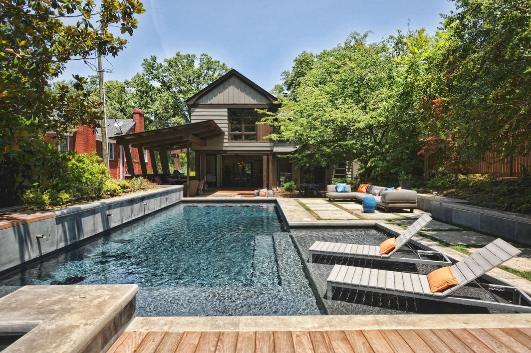 Custom Outdoor Living Space Featuring Hummer Pool and Patio by Hopedale Builders in Charlotte, NC