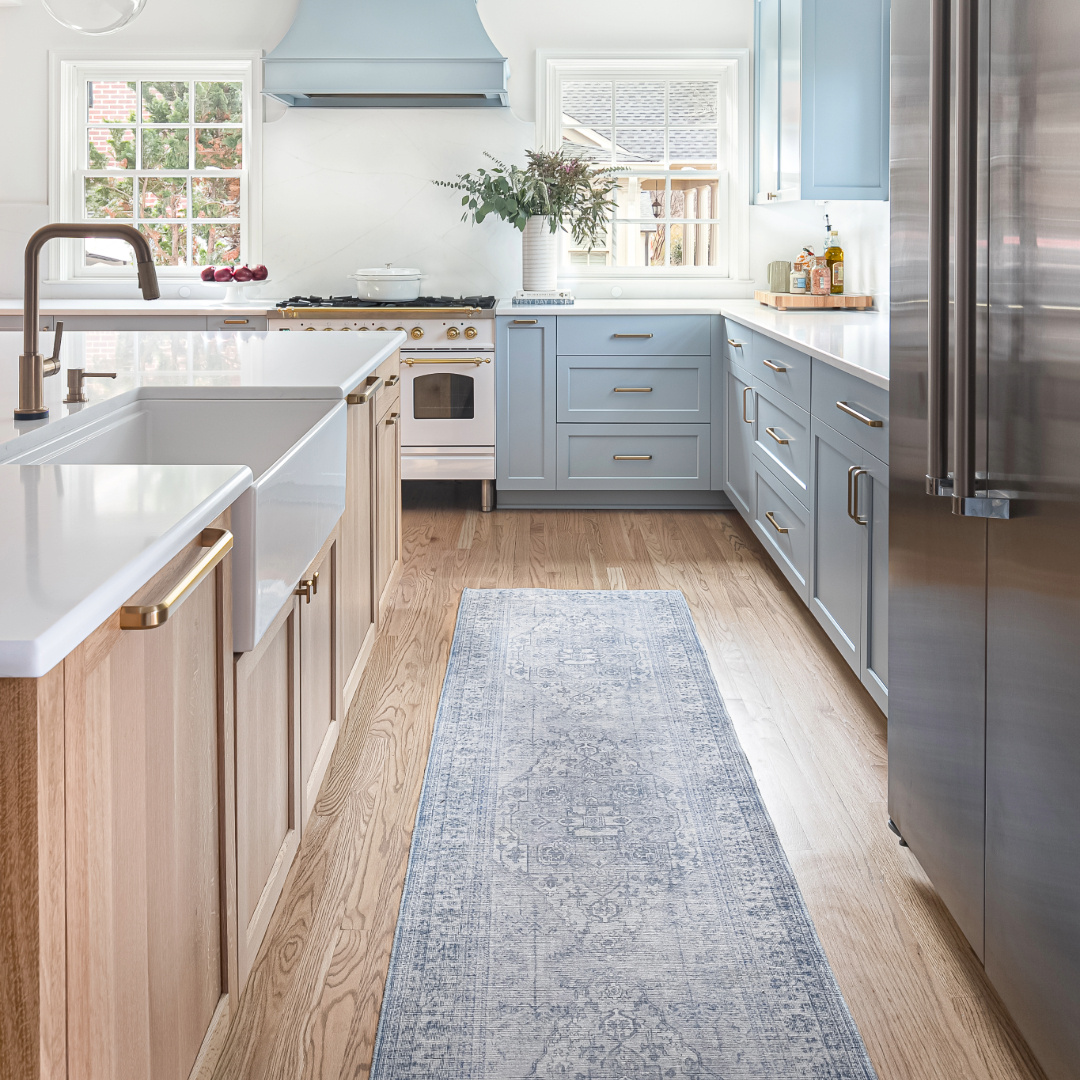Kitchen Remodel featuring coastal farmhouse theme with bright blue and sandy white oak shaker cabinets and an Italian range by Hopedale Builders in Myers Park Charlotte, NC