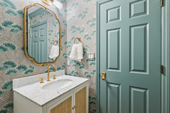 Phillips Remodeled Half Bathroom with Gray and Blue Wallpaper and Brass Mirror and Sink by Hopedale Builders in Charlotte, NC