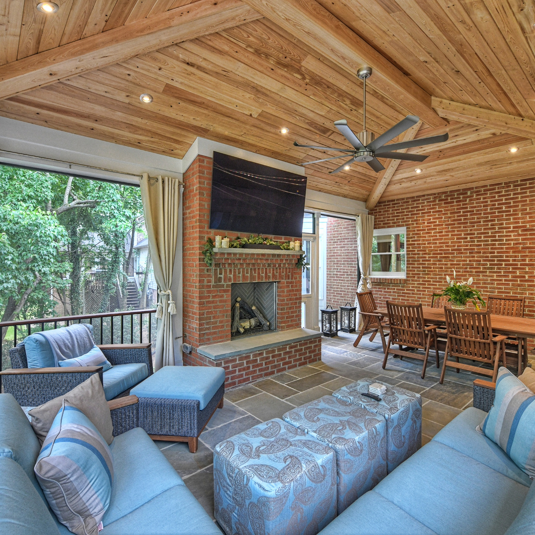 flat screen tv above fireplace in covered porch by Hopedale Builders in Sardis Park Charlotte, NC