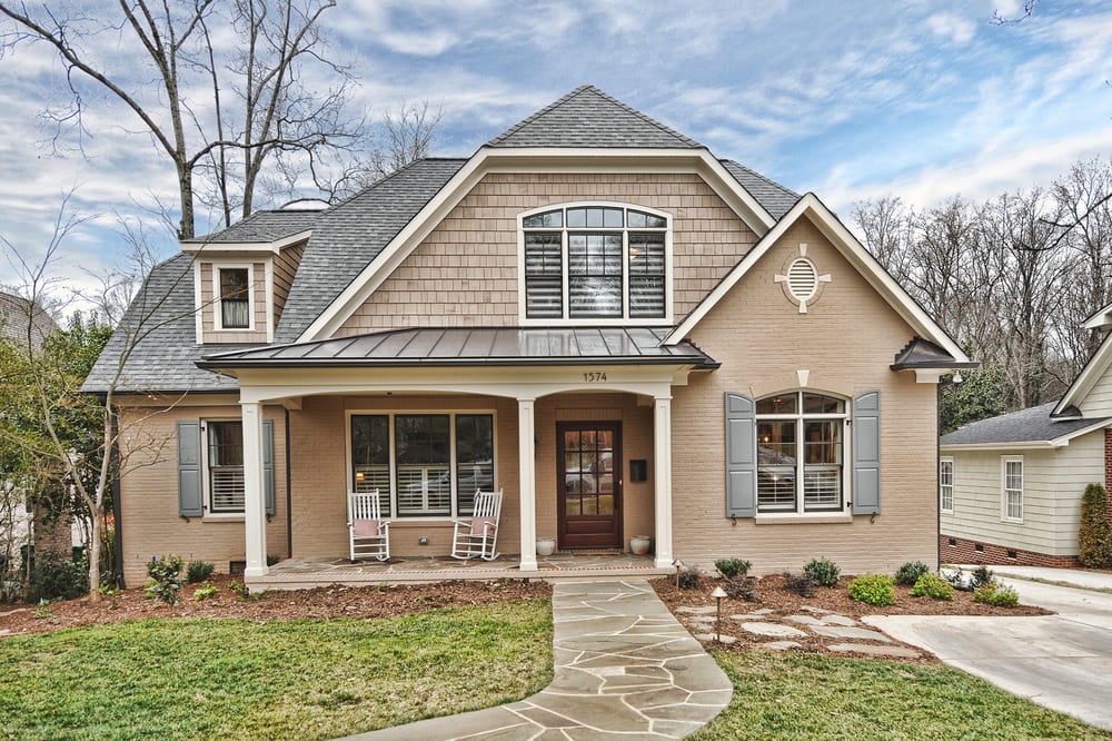 beige house with grey roof with stone walkway by hopedale builders in charlotte