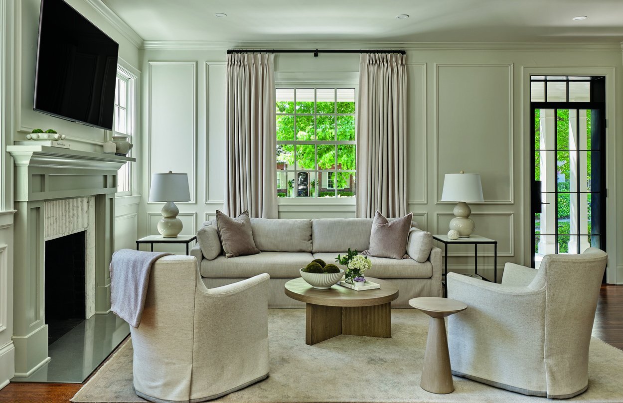 Elegant neutral-toned living room with custom millwork and large windows from an Addition and Whole Home Remodel in Eastover, Charlotte