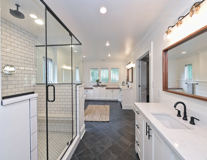 Remodeled bathroom with dark tile and walk in shower by Hopedale Builders in Charlotte, NC