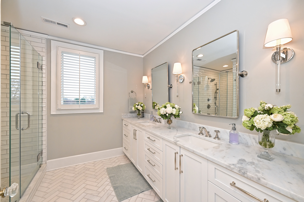 remodeled bathroom with white cabinets, double vanity, and walk in shower by Hopedale Builders in Dilworth, Charlotte, NC