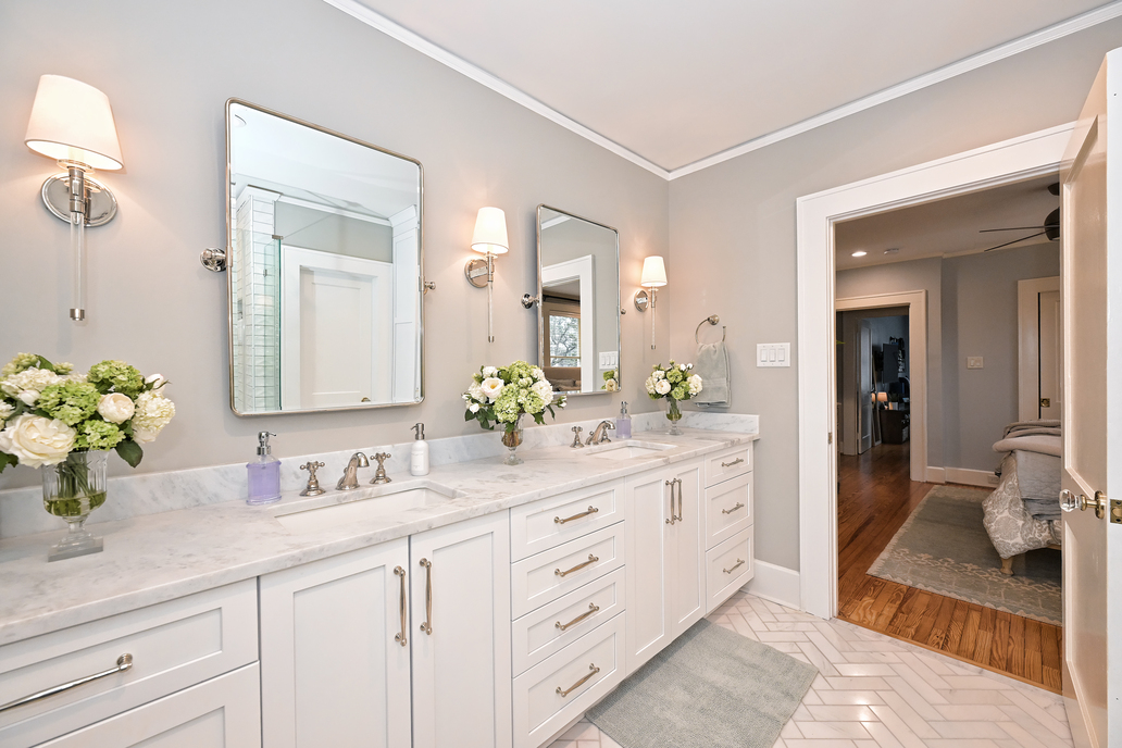 remodeled bathroom with white cabinets and double vanity by Hopedale Builders in Dilworth, Charlotte, NC