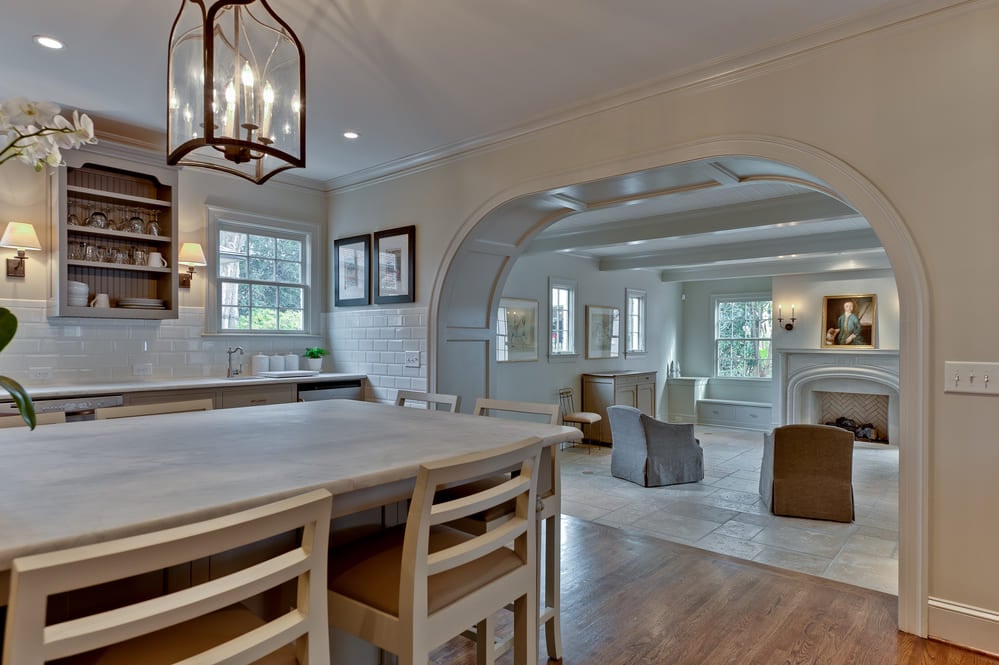 white modern farmhouse kitchen with white island with white barstools by hopedale builders in nc
