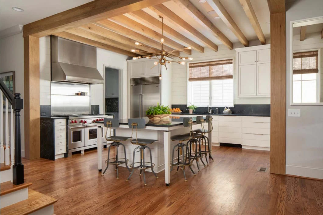 rustic modern kitchen with black countertops and barstools by Hopedale Builders in Charlotte NC