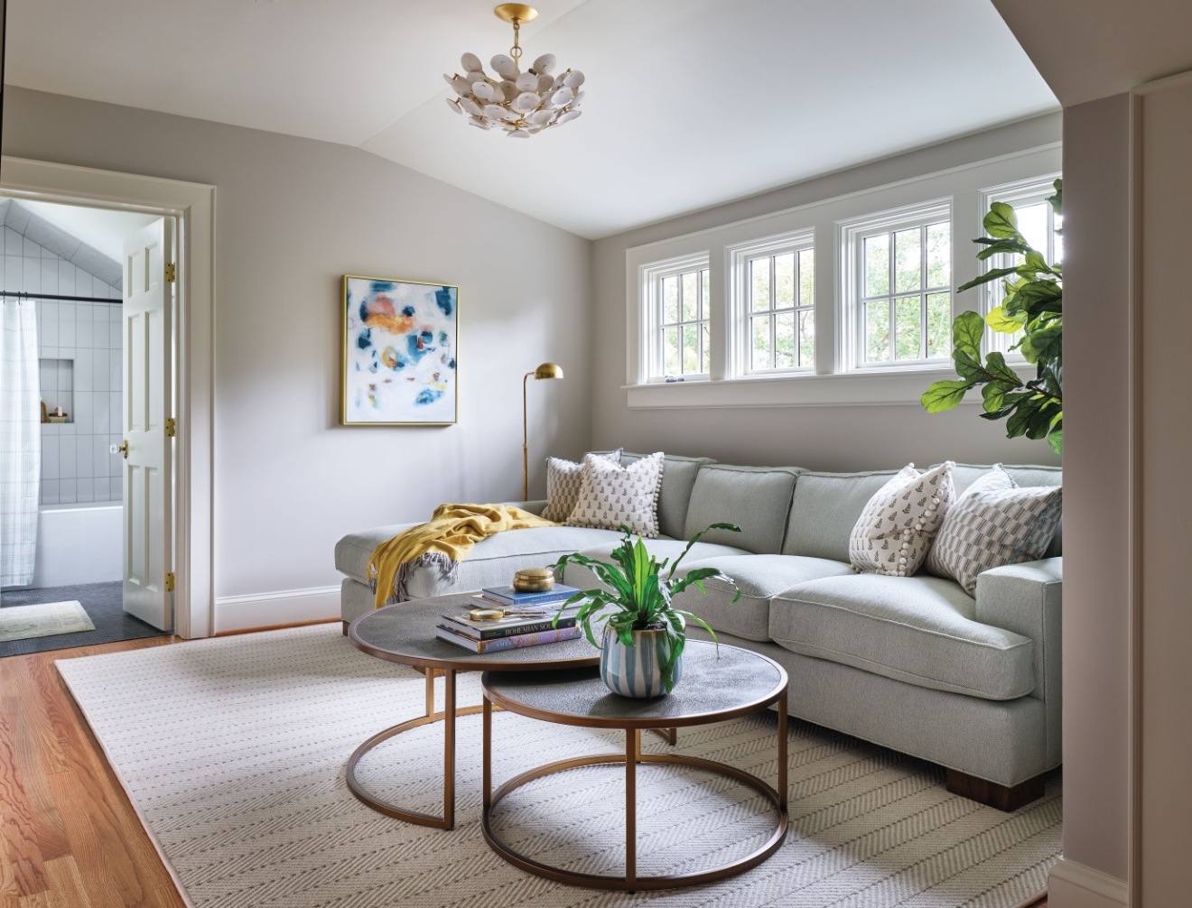 Cozy living space with a neutral color palette, stylish furnishings, and a view of an adjacent bathroom – Addition in Historic Dilworth, NC by Hopedale Builders, Inc.
