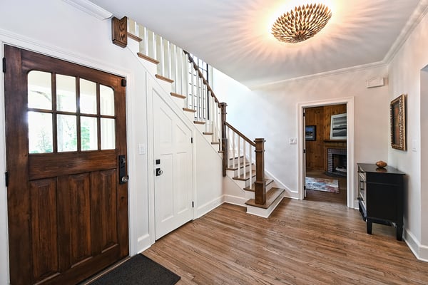 front entrance with brown door and closet under stairs in Charlotte, NC by Hopedale Builders 