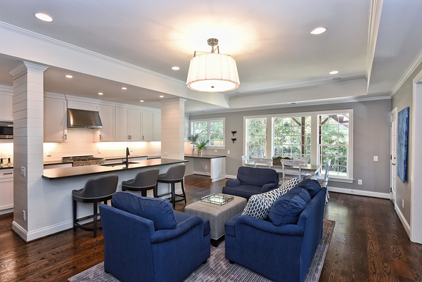 kitchen and living area with blue chairs and brown hardwood floors in Charlotte, NC by Hopedale Builders